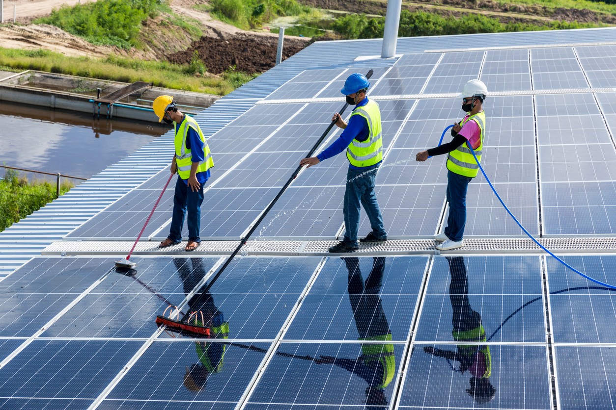 three-workers-cleaning-solar-panels